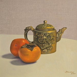 May include: A still life painting of a gold teapot with a dragon design and two orange persimmons on a white surface.