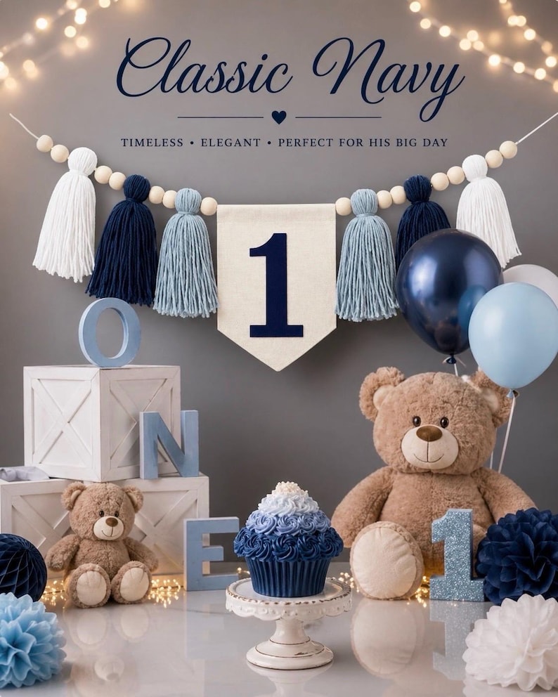 May include: A first birthday party decoration set featuring a banner with white, navy, and light blue tassels, a cream-colored pennant with the number 1, two brown teddy bears, a blue ombre cupcake, and blue and white balloons and paper pom-poms.