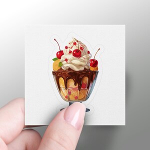 May include: A sticker featuring a delicious-looking sundae. The sundae is in a clear glass dish and is topped with a generous scoop of creamy vanilla ice cream, rich chocolate sauce, and several bright red cherries. The ice cream is nestled between layers of waffle cone pieces. The overall color palette is warm and inviting, with the rich browns of the chocolate and the bright red of the cherries contrasting beautifully with the creamy white of the ice cream. The sticker is perfect for ice cream lovers and adds a touch of sweetness to any surface.