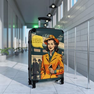 May include: A green suitcase with a retro comic book design featuring a woman in a yellow coat and a hat. The text on the suitcase reads "No need to check the tag, obviously this is not your bag."