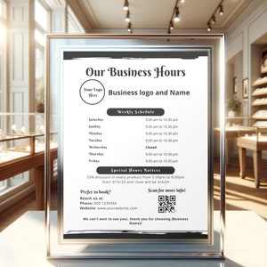 May include: A framed sign detailing business hours, with space for a logo and business name. It features a weekly schedule, special offers, and a QR code. The background shows a jewellery shop with display cabinets.