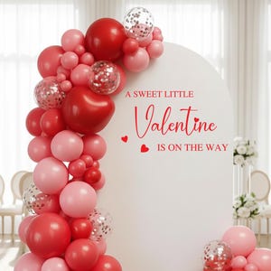 Custom vinyl backdrop decal featuring personalized text in a modern script font. Designed for weddings, birthdays, and special events. Shown applied to a solid wall for a clean, professional look. Ideal for use behind dessert tables, photo booths, or ceremony spaces. Available in various sizes and colors to match your theme. Easy to apply and made for temporary or semi-permanent use. Perfect for adding a personal touch to any celebration.