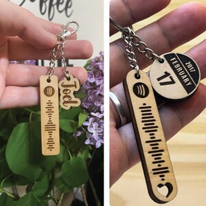 May include: A wooden keychain with a Spotify barcode, a heart, and the name "Joel" engraved on it. The keychain also includes a round wooden tag with the date "February 17, 2017" engraved on it.