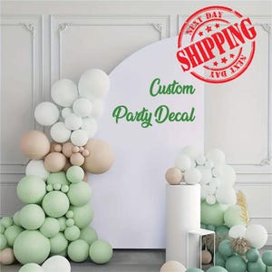 Custom vinyl decal displayed on a smooth backdrop surface, featuring clean, single-color lettering designed for events, mirrors, walls, and party decor. The decal is made from high-quality adhesive vinyl with smooth edges and a professional finish. Suitable for birthdays, baby showers, weddings, and home decor, this removable vinyl decal is easy to apply and creates a polished, modern look on flat surfaces.