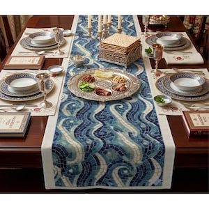 May include: A Passover Seder table setting with a blue and white mosaic patterned table runner. The table is set with plates, bowls, silverware, and a silver Seder plate with traditional foods. A stack of matzah is in a decorative holder.