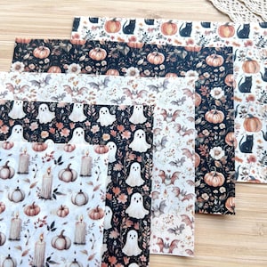May include: A collection of five rectangular sheets of patterned craft material featuring Halloween-themed illustrations. The designs include black cats, orange pumpkins, white ghosts, brown bats, and lit candles arranged in repeating patterns on light and dark backgrounds.