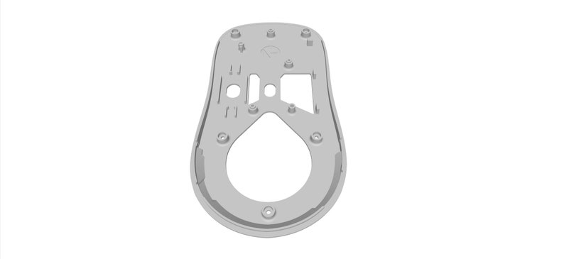 May include: A gray plastic mouse shell with a cutout design and several holes for screws. The shell is designed for a computer mouse.