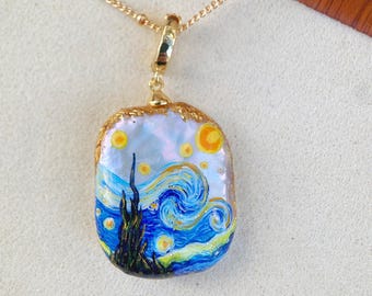 May include: Gold-toned necklace with a rectangular pendant featuring a miniature painting of Van Gogh's "Starry Night." The pendant has a gold-colored border and is suspended from a delicate chain.