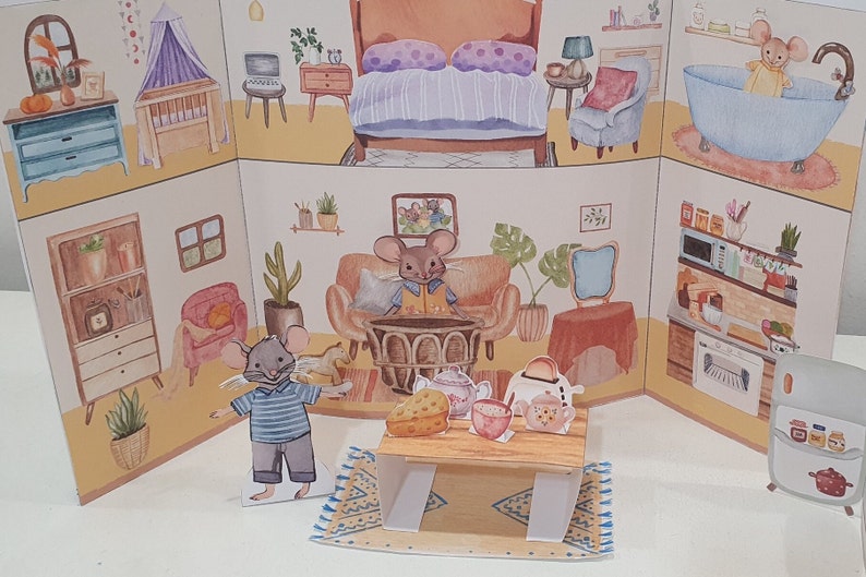 May include: A papercraft dollhouse with a blue and white bedroom, a living room with a brown couch, a kitchen with a white refrigerator, and a bathroom with a blue bathtub. The dollhouse is decorated with small, colorful details, such as flowers, plants, and furniture.