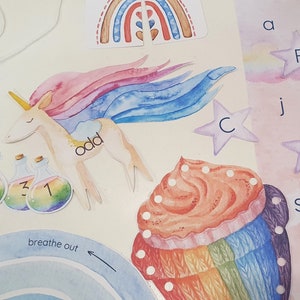 May include: A set of colorful educational flashcards featuring a unicorn, a cupcake, a rainbow, and letters of the alphabet. The unicorn is pink and blue with a white mane and tail. The cupcake is decorated with rainbow frosting and sprinkles. The rainbow is made of red, orange, yellow, green, blue, indigo, and violet. The letters are in a rainbow font.