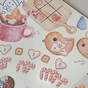 May include: A set of colorful Christmas-themed educational stickers with numbers, candy canes, and a gingerbread house. The stickers are perfect for teaching children about math and counting.
