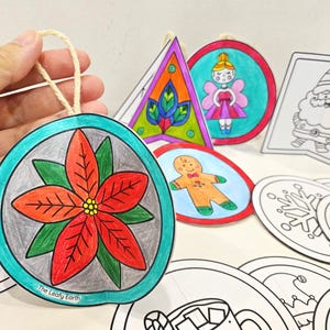 May include: Hand-colored Christmas ornaments in various shapes, including a poinsettia, fairy, and gingerbread man. The ornaments are outlined in black and feature bright colors. Some ornaments are blank and ready to be colored.
