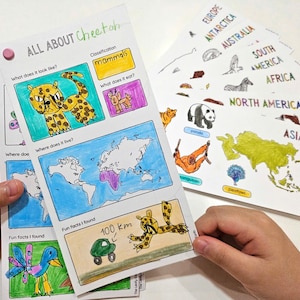 May include: Educational printables featuring colorful illustrations and text about cheetahs and world geography. The "All About Cheetah" page includes drawings and facts. Additional pages highlight continents and animals. The pages are held together with a pink push pin.