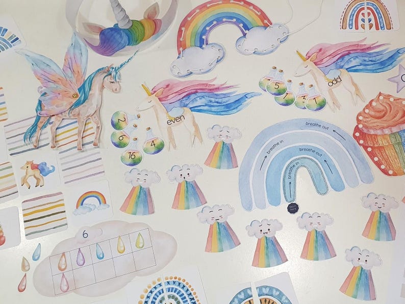 May include: A set of colorful educational flashcards featuring rainbows, clouds, unicorns, and other whimsical illustrations. The cards include words like "even", "odd", "breathe in", and "breathe out".