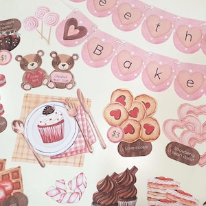 May include: A collection of watercolor-style paper cutouts featuring baked goods and sweets. Includes cupcakes, macarons, cookies, waffles, and chocolate-covered strawberries. A banner spells out "Bake the", and there are teddy bear cutouts.