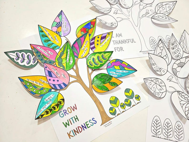 May include: A colorful paper tree with leaves, each decorated with unique patterns and inspirational messages. The tree trunk is brown, and the leaves are various colors. The words "GROW WITH KINDNESS" are at the base of the tree.