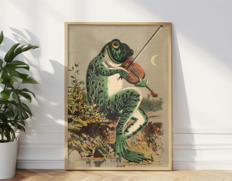 May include: A vintage illustration of a green frog playing a violin. The frog is sitting on a rock with green foliage behind it. The frog is wearing a white shirt and has a black bow tie. The violin is brown and has a white bow. The background is a light brown color with a crescent moon in the upper right corner.