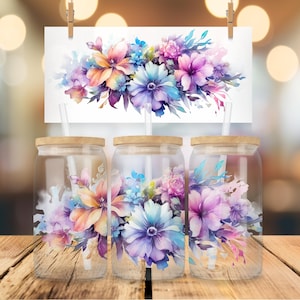 May include: Three clear glass tumblers with wooden lids and straws. Each tumbler features a watercolor floral design with pink, purple, blue, and orange flowers.