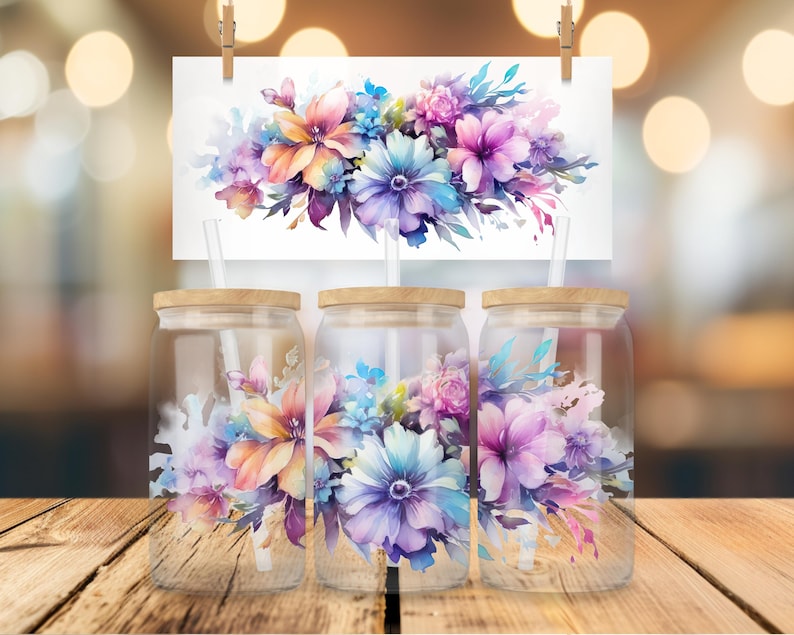 May include: Three clear glass tumblers with wooden lids and straws. Each tumbler features a watercolor floral design with pink, purple, blue, and orange flowers.