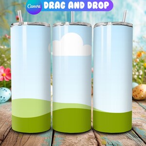 May include: Three stainless steel tumblers with a white cloud and green grass design. The tumblers are on a wooden surface with Easter eggs in the background.