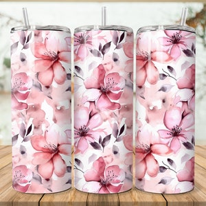 Puede incluir: Tres vasos de acero inoxidable con dise&ntilde;os florales de acuarela rosa y gris. Los vasos tienen tapas y pajitas.