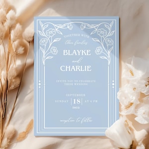 May include: A light blue wedding invitation with white floral accents and text. The invitation reads "Together with their families, Blayke and Charlie invite you to celebrate their wedding, Sunday, September 18, 2023 at 4 PM. Reception to follow."