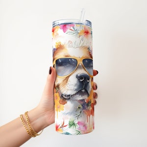 May include: A stainless steel tumbler with a white background and a colorful floral design. The tumbler features a dog's face with sunglasses and a floral pattern.