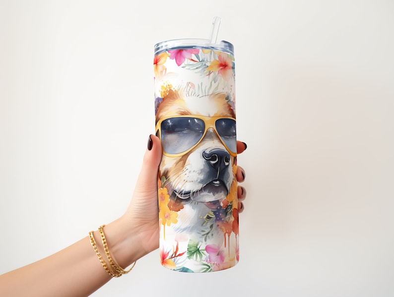 May include: A stainless steel tumbler with a white background and a colorful floral design. The tumbler features a dog's face with sunglasses and a floral pattern.