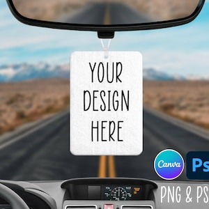 May include: White car air freshener with the text "YOUR DESIGN HERE" hanging from the rearview mirror of a car. The car is driving down a desert road.