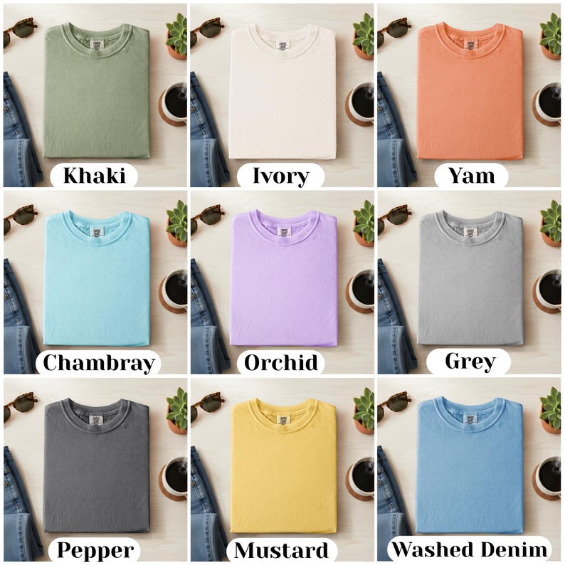 May include: Nine folded t-shirts in various colors, including khaki, ivory, yam, chambray, orchid, grey, pepper, mustard, and washed denim. Each shirt is displayed with a pair of sunglasses, a small plant, and a cup of coffee.