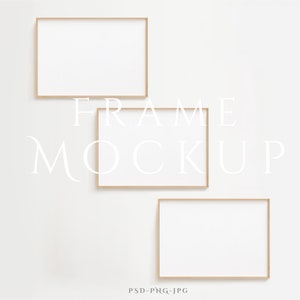 May include: Three empty picture frames with a light wood finish, arranged on a white wall. The frames are rectangular and have a simple, modern design. The text "FRAME MOCKUP" is printed in white below the frames.