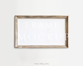 May include: A light brown wood frame with a white mat and the text "FRAME MOCKUP" printed in white on the mat.