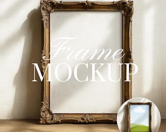 May include: A large, ornate, gold-colored picture frame with intricate detailing. The frame is empty, with the words "Frame MOCKUP" in white script across the center. A smaller framed image is in the lower right corner. The image is on a wooden surface.