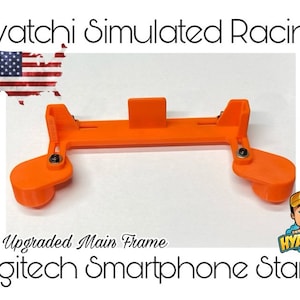 May include: Orange 3D printed plastic stand for a Logitech smartphone. The stand is designed for simulated racing and has the text "Upgraded Main Frame" printed on it.