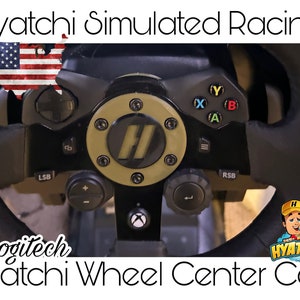 May include: A black Logitech steering wheel with a gold Hyatchi center cap. The steering wheel has buttons and a  'Hyatchi Simulated Racing' logo.