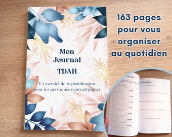 May include: A pink and blue floral patterned journal with the title "Mon Journal TDAH" and the text "L'essentiel de la planification pour les personnes neuroatypiques". The journal has 163 pages and is designed to help people organize their daily lives.