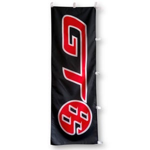 May include: Black banner with a red and white logo. The logo is a stylized "GT" with a red circle containing a stylized "H" inside.