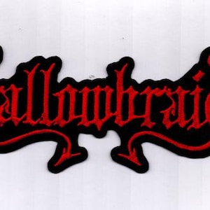 May include: A black patch with red embroidered text that reads "Challombraid" in a gothic font. The patch has a red border and a unique, stylized shape, suitable for clothing or accessories.