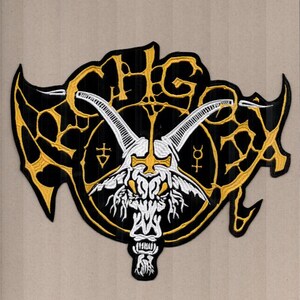 May include: Black and gold embroidered patch featuring a goat skull with horns, a cross, and the letters "CHG". The patch has a black background with gold accents and a white goat skull.