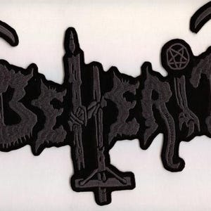 May include: Black and gray embroidered patch with the word "BEHERIT" in a gothic font. The patch features a pentagram, a candle, and other dark imagery, suitable for jackets or bags.