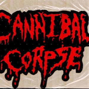 May include: A black and red graphic design featuring the words "CANNIBAL CORPSE". The text is in a dripping, stylized font, with red letters against a black background. The design has a grunge aesthetic.