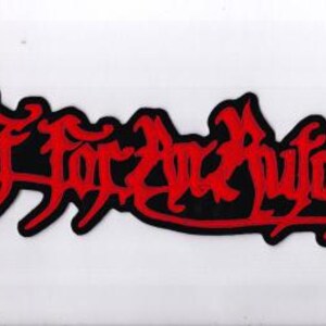 May include: A black patch with the words "Fit for an Autopsy" in red, stylized lettering. The text is outlined in black and set against a white background. The patch has a jagged edge.