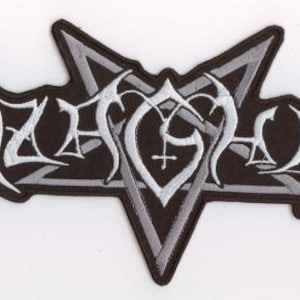 May include: A black and white embroidered patch featuring the word "AZAZEL" in a gothic font. The patch has a pentagram shape with a bat-wing design on each side. The text is in white, and the border is black.