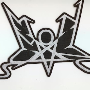 May include: Black and white embroidered patch featuring a stylized pentagram with angular wings and a central circle. The design has a bold, graphic quality, suitable for jackets, bags, or other apparel.