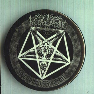May include: A round, black button featuring a white pentagram with a goat-like skull in the center. The button has the text "Necrophobic" at the top and "Stormed By Evil" at the bottom, all in a gothic font.