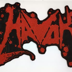 May include: A black patch featuring the word "HAVAK" in red, designed with a dripping blood effect. The patch has an irregular shape, suitable for application on clothing or accessories.