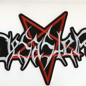 May include: A black and white embroidered patch featuring the word "DEICIDE" in a stylized font, set against a red pentagram. The patch has a black border.