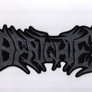 May include: A black and gray patch with the word "BRUTALIZED" in a stylized, gothic font. The patch has a jagged, irregular border and is set against a white background.