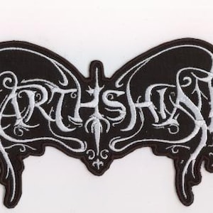 May include: Embroidered black and white patch featuring the word "EARTHSHINE" in a decorative font. The patch has a symmetrical design with curved edges and ornamental details, suitable for clothing.