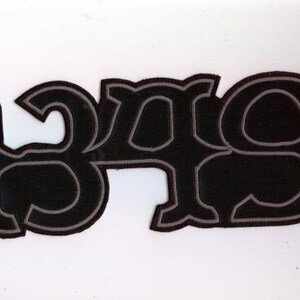 May include: Black patch with the number "349" in a stylized font. The numbers are outlined in gray, with a black fill. The patch is on a white background.